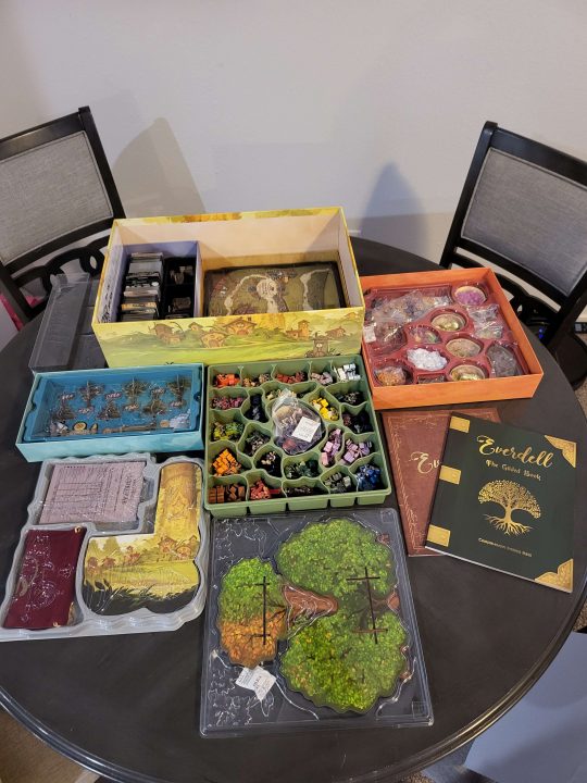 All the game pieces laid out in Everdell: The Complete Collection