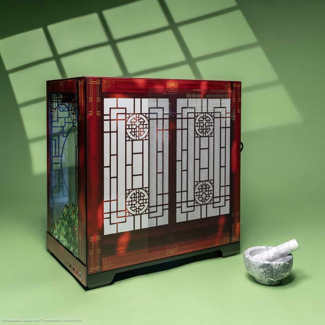 041326-Apothecary_Diaries-social-09_1x1 | The Outerhaven Red ornate computer tower with geometric lattice panels sits on a green surface, next to a marble mortar and pestle.