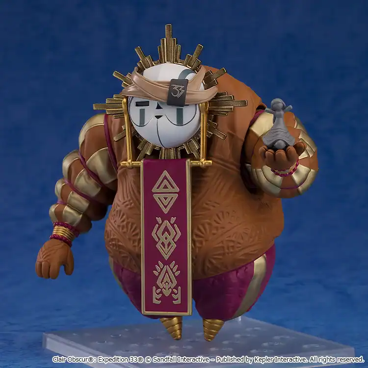Sun-themed humanoid action figure in a brown ornate robe, with a gold sunburst crown, holding a tiny gray statue in its right hand.