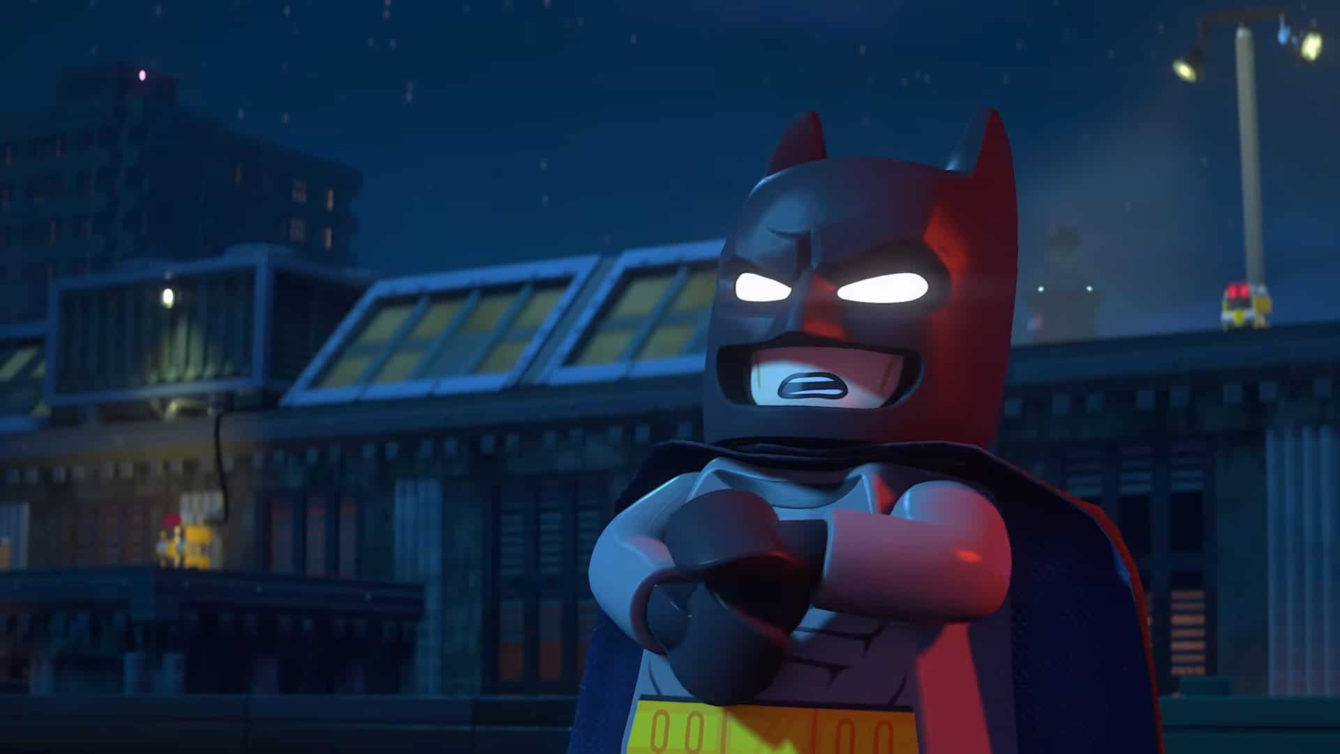 LEGO® Batman™_ Legacy of the Dark Knight Official Launch Trailer 1-38 screenshot | The Outerhaven LEGO Batman in a cape on a rooftop at night, pointing forward with glowing eyes.