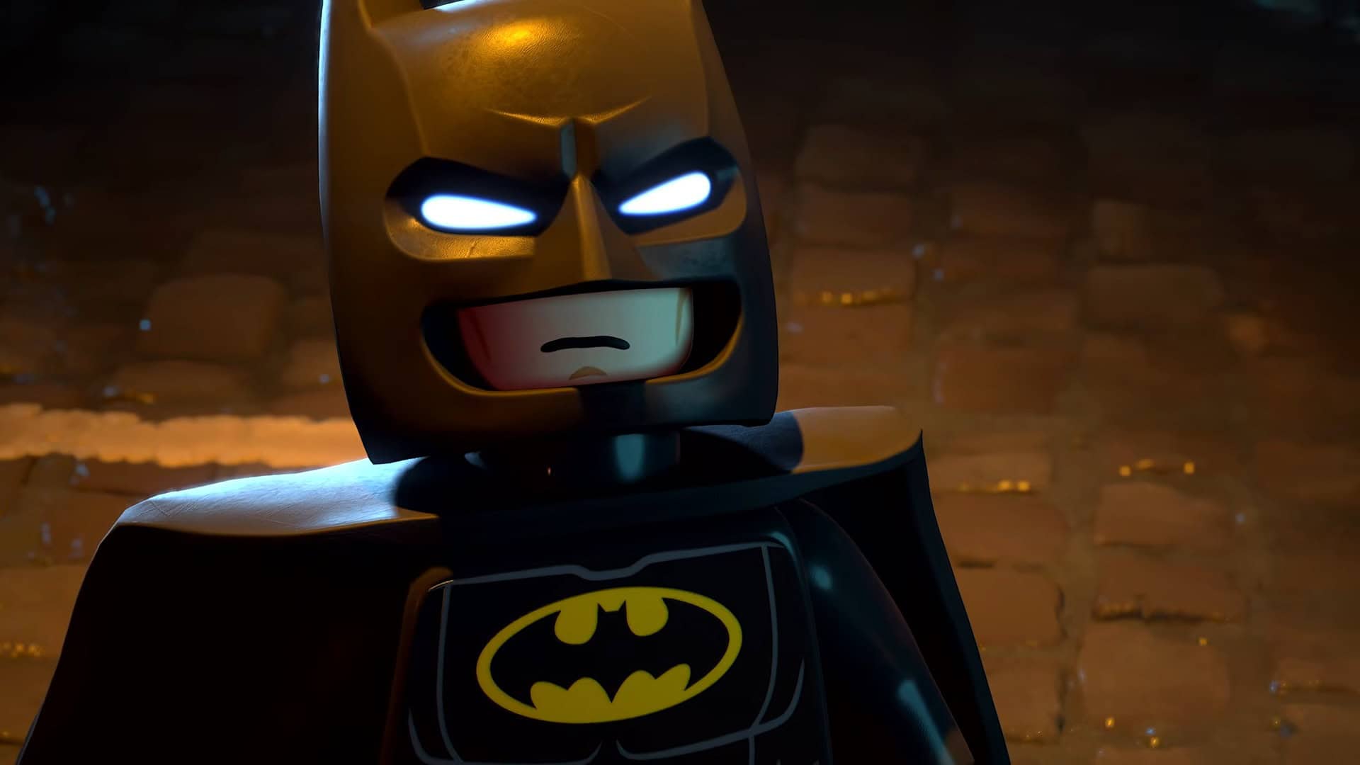 LEGO® Batman™_ Legacy of the Dark Knight Official Launch Trailer 1-9 screenshot | The Outerhaven Close-up of a LEGO Batman minifigure in a dark alley, with glowing blue eyes and the yellow bat emblem on the chest.