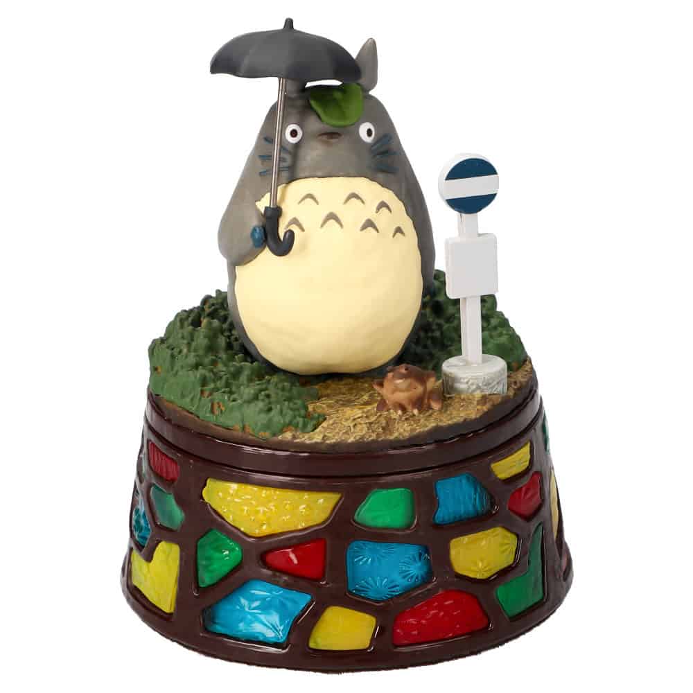 1 Totoro and the Bus Stop Accessory box My Neighbor Totoro | The Outerhaven Totoro-themed cake topper: a gray Totoro holding a black umbrella, standing on a grassy cake base with a multicolored mosaic pedestal.