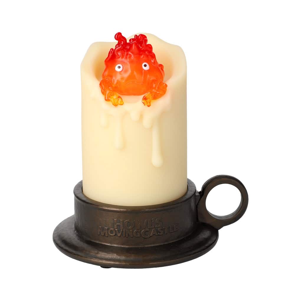5 Swinging Calcifer LED Candle Howl_s Moving Castle | The Outerhaven Cream-colored pillar candle with a red dragon figure emerging over the wax, sitting on a dark metal base.