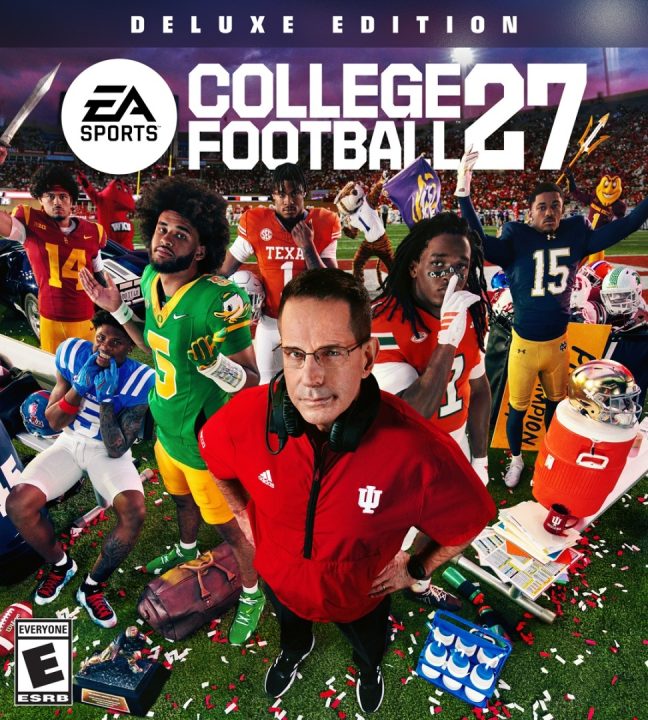 Video game cover for EA Sports College Football 27 Deluxe Edition showing a coach in a red Indiana hoodie amid diverse players on a football field with confetti and stadium backdrop, text'DELUXE EDITION' and 'COLLEGE FOOTBALL 27'
