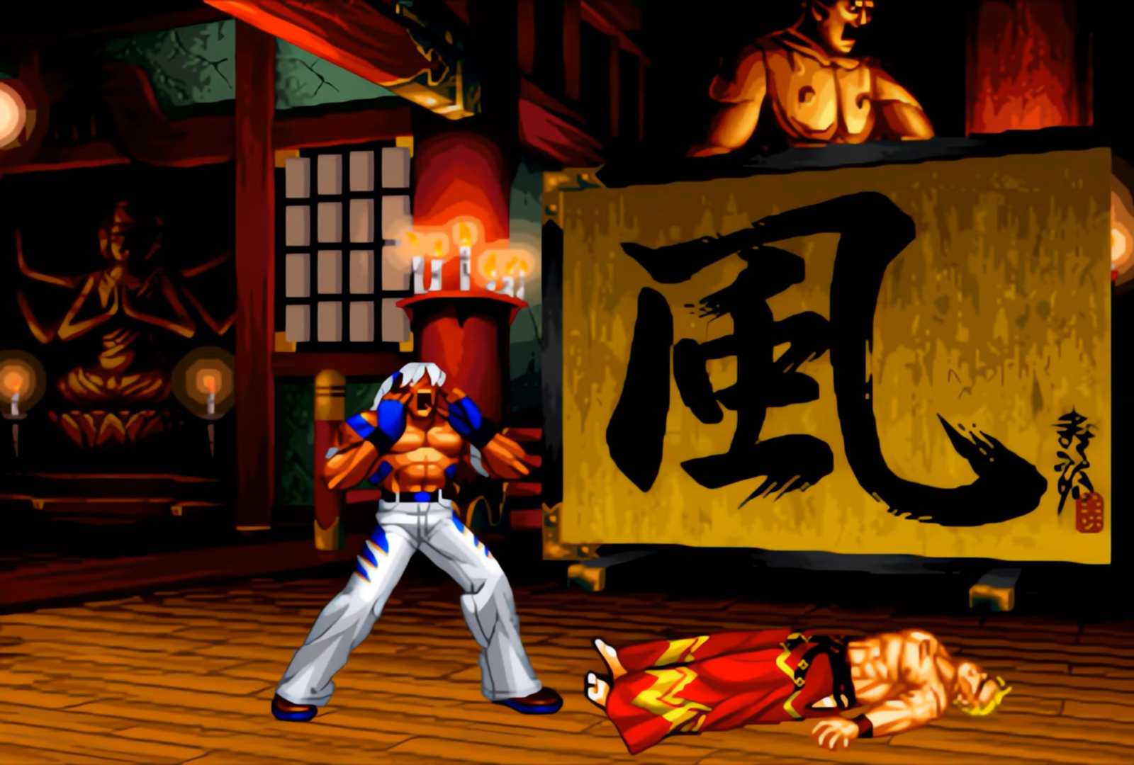Muscular fighter in white pants and blue gloves looms over a downed opponent in a dojo, with a large gold kanji banner in the background.