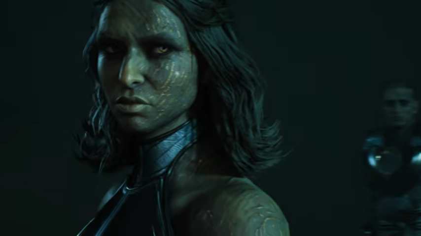 Star Wars Zero Company _ Official Gameplay Trailer 1-18 screenshot | The Outerhaven Female humanoid with blue-green skin and glowing facial patterns looks intently to the side in a dark setting with cool lighting.