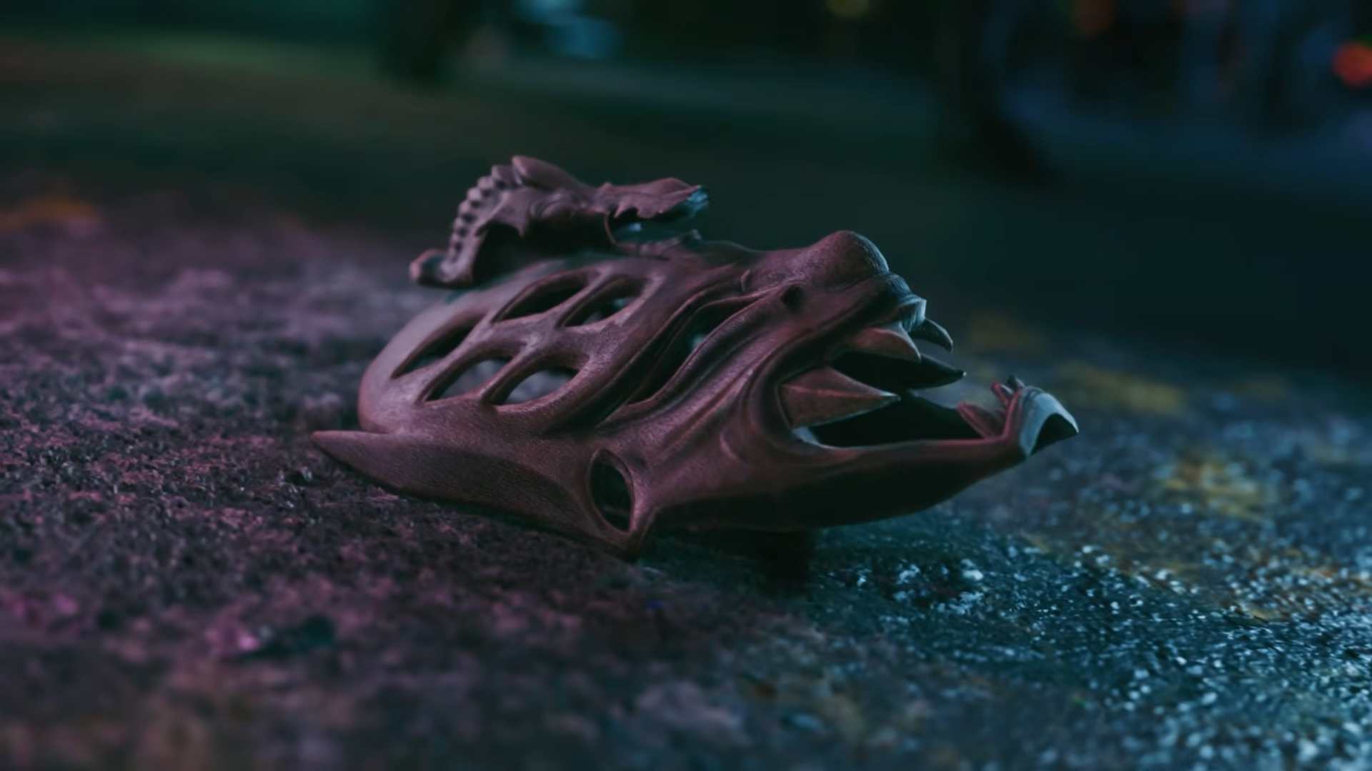 VIRTUA FIGHTER CROSSROADS_ Bakunawa Killer Announcement Trailer 0-27 screenshot | The Outerhaven Weathered reptile skull lying on a wet, purple-lit pavement at night.