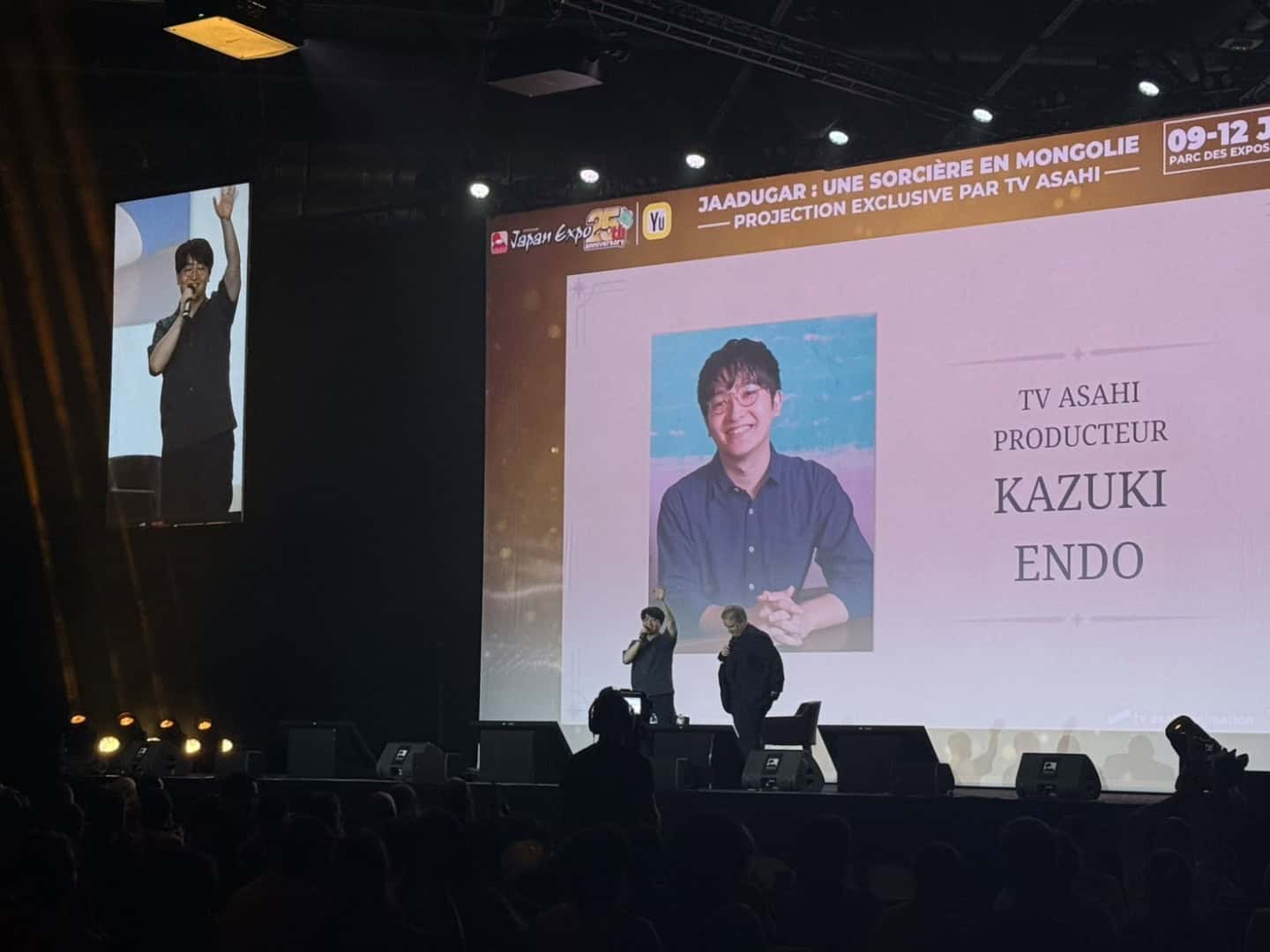Japan Expo | The Outerhaven Speaker on stage at a convention with a large screen showing a portrait and 'KAZUKI ENDO' text above the audience