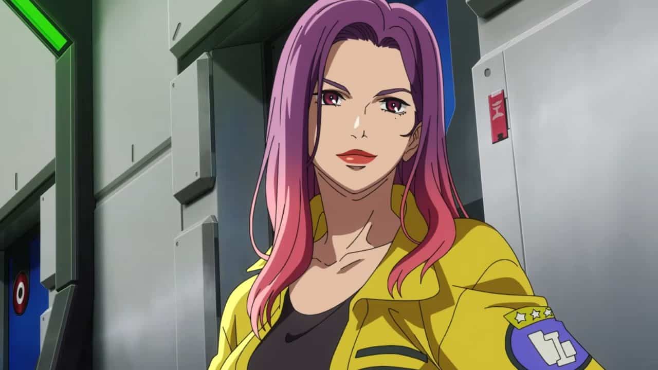 _Mobile Suit Gundam RG XARX-ZERO_ Teaser 0-47 screenshot 1 | The Outerhaven Anime-style woman with pink hair and red lips in a yellow jacket in a futuristic corridor.