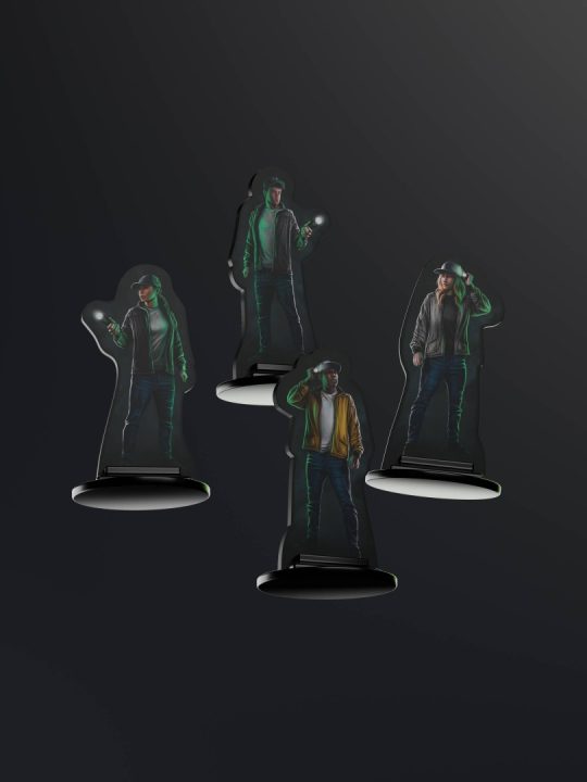 Player Standees | The Outerhaven Four life-size standee cutouts of a person in a jacket and hat, each holding a small light, on black bases against a dark background.