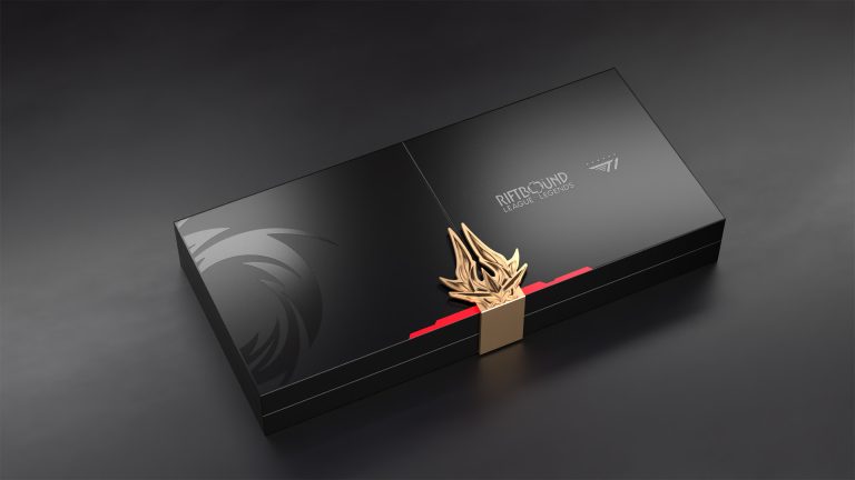 Riftbound x T1 2025 Worlds Champion Collection Box Image 2 | The Outerhaven Black rectangular gift box with a gold flame ornament and a red inner edge, branded Riftbound League of Legends, on a dark surface.