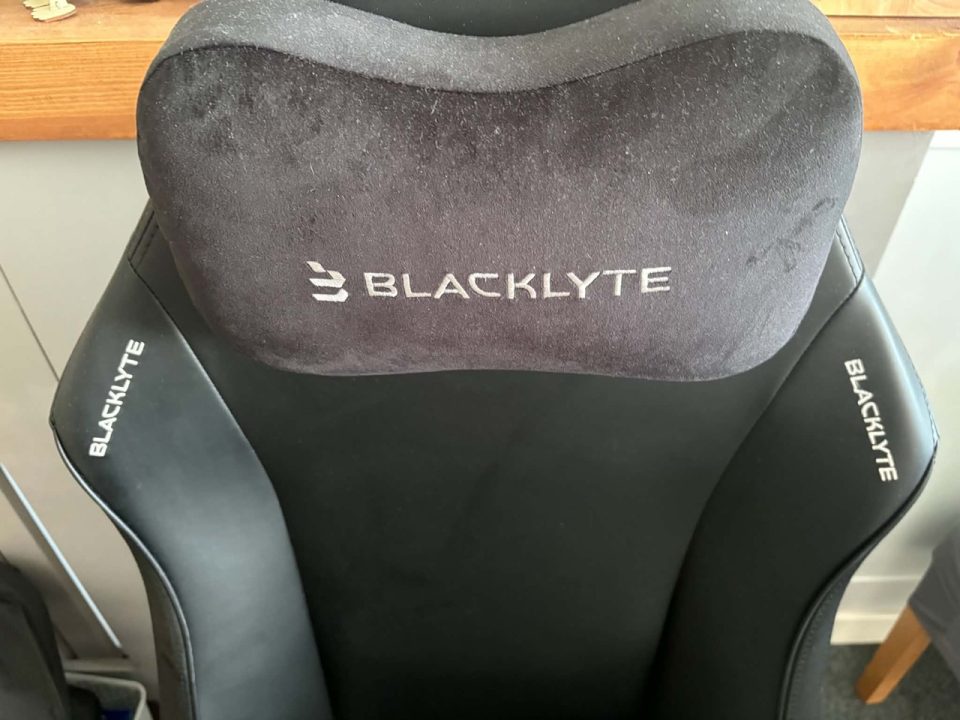BAP Pillow | The Outerhaven Gaming chair with black upholstery, padded headrest showing the BLACKKYTE logo, and branding on the shoulder panels.