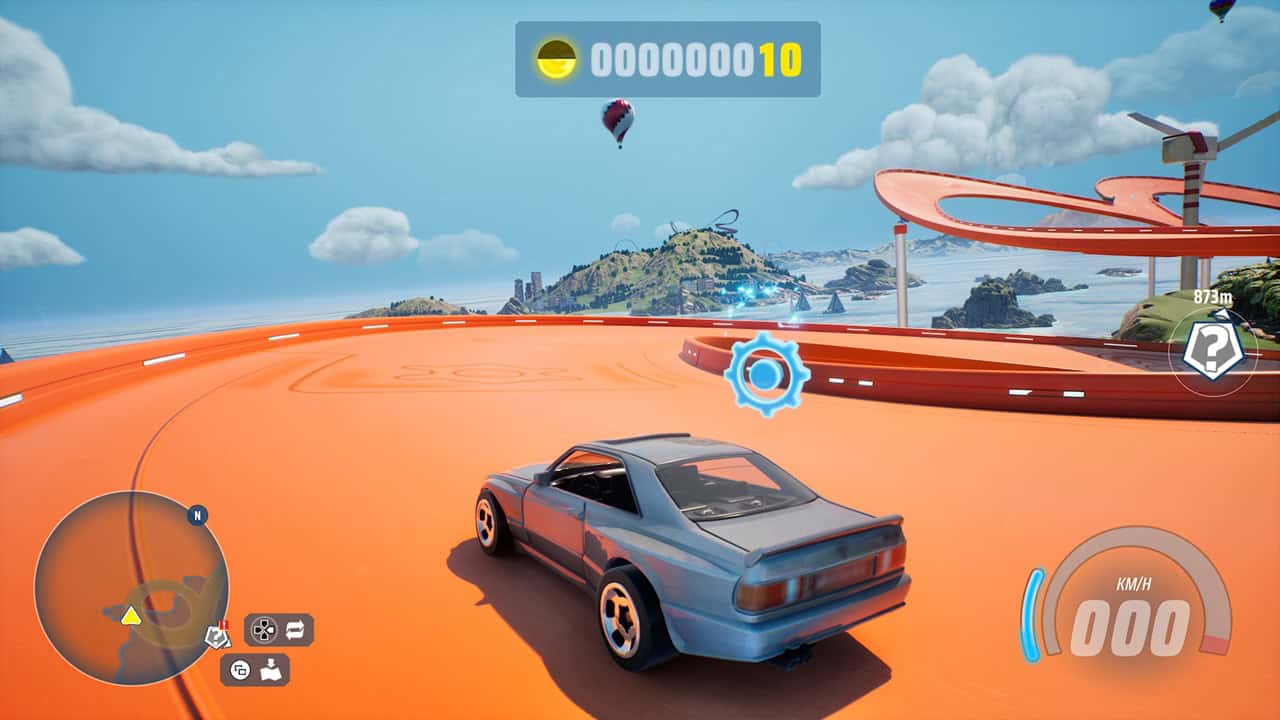 HOT WHEELS™ Infinite Rush-Gears | The Outerhaven Blue sports car on a bright orange race track with coastal islands in the distance and looping track structures ahead, in a racing game.