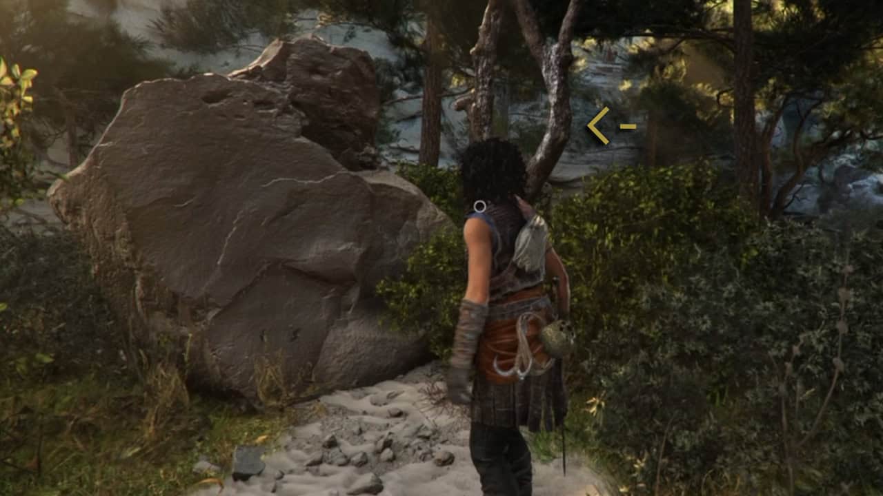 pt 3 | The Outerhaven In-game warrior-like character with armor and a backpack stands on a rocky forest path beside a large boulder.